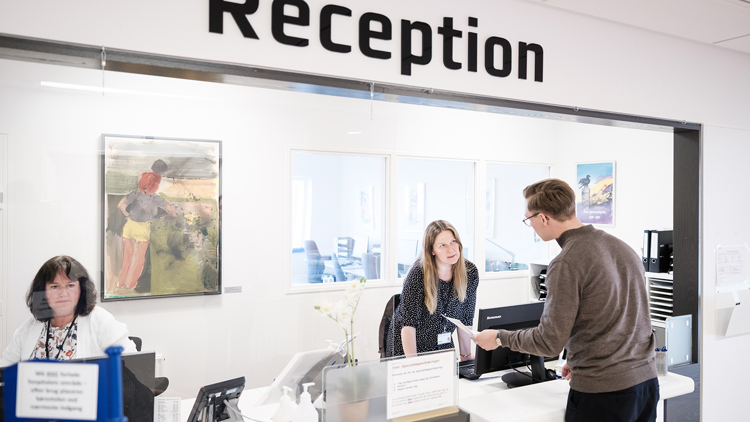Patient taler med receptionist.